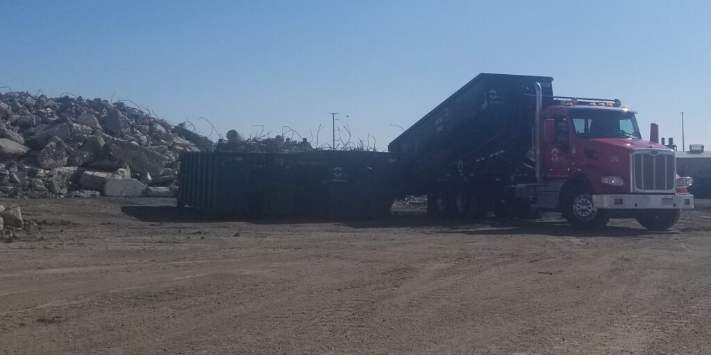 Customer dumping used aggregate rubble at Colorado Aggregate Recycling's yard.